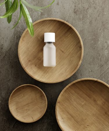 Pedestal for natural cosmetic product presentation. Stone and wood cylinders with plant leaves. 3d illustration.